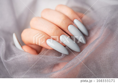 Grey nails on grey lace background. Grey nails on grey lace background. 108333171