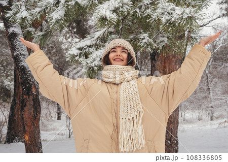 Enjoying of Snowy Frosty Winter Weather of Young Woman in Day Forest Enjoying of Snowy Frosty Winter Weather of Young Woman in Day Forest 108336805