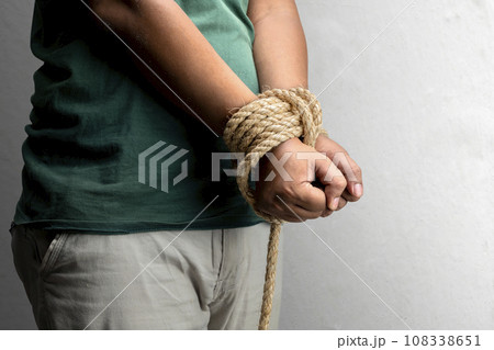 The man's hands are tied by rope 108338651
