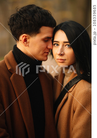 Young couple in love walking in the park on a autumn day. Enjoying time together. Young couple in love walking in the park on a autumn day. Enjoying time together. 108339685