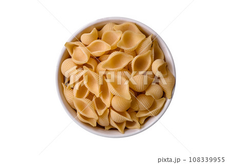 Raw Italian pasta conchiglie from durum wheat with vegetables, salt and spices 108339955