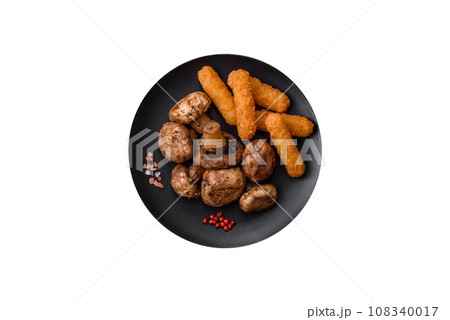Delicious juicy whole champignons baked on the grill with salt and spices 108340017