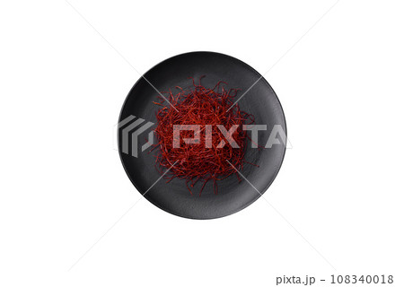 Red thin hot chili threads on a dark background 108340018