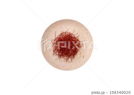 Red thin hot chili threads on a dark background 108340020