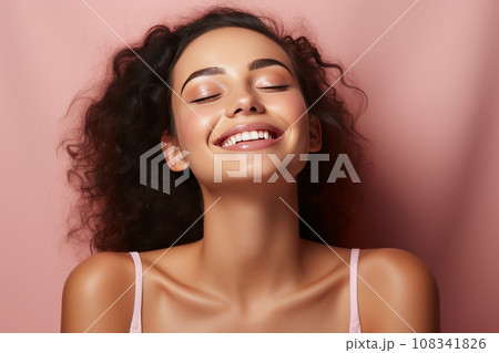 Young girl with perfect skin on her face on a pink background, a happy girl enjoys the freshness of her skin after skin care procedures Young girl with perfect skin on her face on a pink background, a happy girl enjoys the freshness of her skin after skin care procedures 108341826