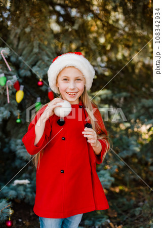 Christmas children elf ears. Child waiting for Christmas in wood. portrait of little girl decorating christmas tree. winter holidays and people concept. Happy Holidays. Christmas children elf ears. Child waiting for Christmas in wood. portrait of little girl decorating christmas tree. winter holidays and people concept. Happy Holidays. 108342934