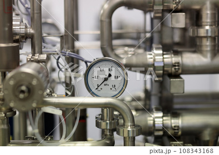 close up of stainless steel pipes and gauge 108343168