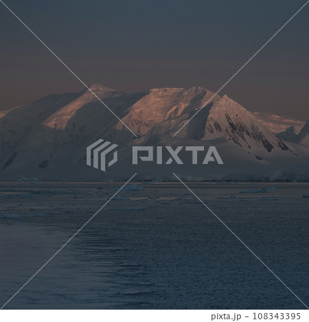 Lemaire strait coastal landscape, mountains and icebergs, Antarctic Peninsula, Antartica. 108343395