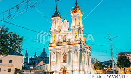 Vitebsk, Belarus. View On Church Of Resurrection Of Christ On Market Square In Evening Or Night Illuminations. Bold Colors. Famous Landmark. Travel Destinations. Traffic Car Lights Motion 108343414