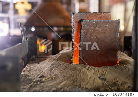 Ferrous metal billet is melted in an induction furnace closeup Ferrous metal billet is melted in an induction furnace closeup 108344187