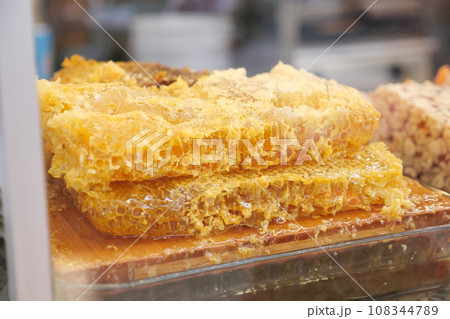 close up of fresh honey with comp in a jar  108344789