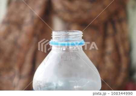 open a cap of a plastic water bottle  108344990