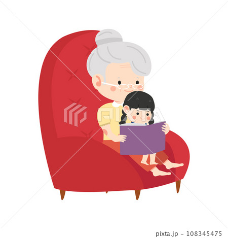 grandmother sits in a chair and reads a book to her granddaughter 108345475