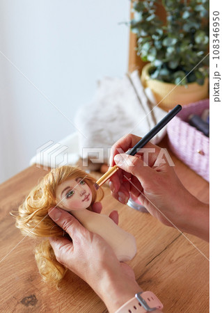 Creative woman painting handmade doll face. Creative woman painting handmade doll face. 108346950