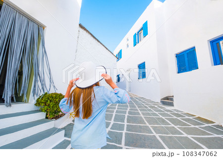 Little girl walking on a greek street 108347062