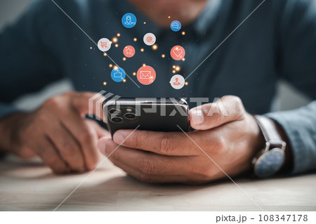 Digital connectivity at home man chats on smartphone, discussing live chat social network concepts. Icons appear in chat box, portraying modern communications role. Social media marketing technology 108347178