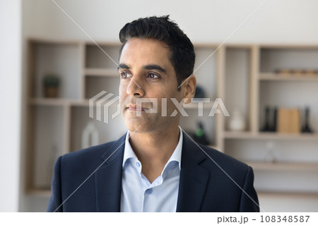 Serious pensive CEO man in formal suit posing in office 108348587