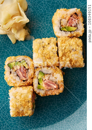 Warm sushi rolls with tuna and avocado. 108349151