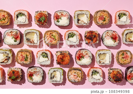 Various sushi rolls on pink background, top view. Various sushi rolls on pink background, top view. 108349398