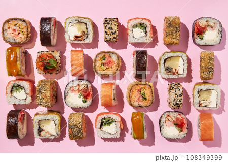 Various sushi rolls on pink background, top view. 108349399
