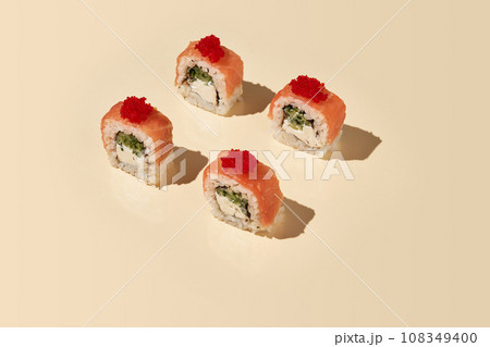 Philadelphia rolls with salmon on beige background. Philadelphia rolls with salmon on beige background. 108349400