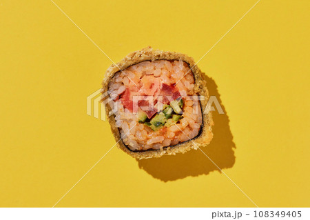 Hot sushi roll with shrimp on yellow background. Hot sushi roll with shrimp on yellow background. 108349405