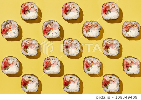 Sushi rolls pattern on yellow background. Sushi rolls pattern on yellow background. 108349409