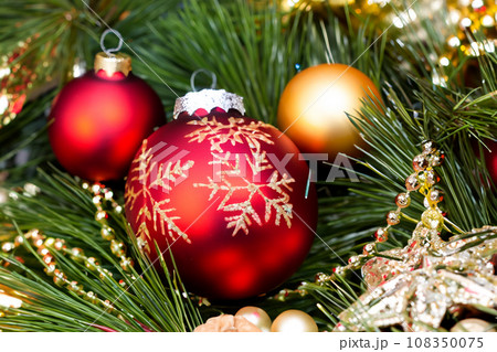 Christmas decorations. Christmas 2023 2024. Big set of Christmas fir garlands with berries and red cones. Close the balls on the Christmas tree. Bokeh grains in the background. New Year concept. 108350075