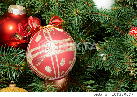 Christmas decorations. Christmas 2023 2024. Big set of Christmas fir garlands with berries and red cones. Close the balls on the Christmas tree. Bokeh grains in the background. New Year concept. 108350077