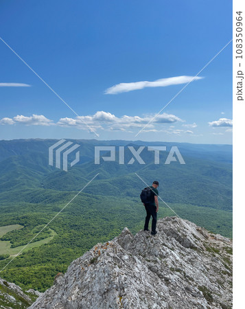a man standing on a mountain hiking journey nature hike 108350964