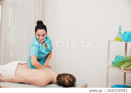 healthy back woman massages client in massage room spa training healthy back woman massages client in massage room spa training 108350991