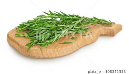 Rosemary twig and leaves on a wooden board isolated on white background Rosemary twig and leaves on a wooden board isolated on white background 108351538