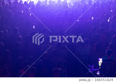 A crowd of people on concert in blue light at a concert. 108351824