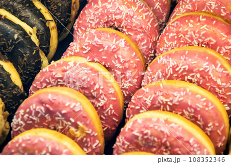 Appetizing colorful donuts closeup, background or texture Appetizing colorful donuts closeup, background or texture 108352346