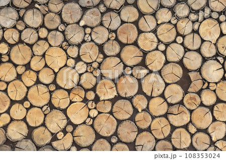 Stacking Wooden Logs. Wall of stacked wood logs as background 108353024