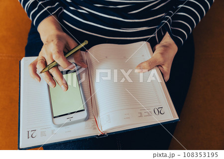 female entrepreneur at work. Work at home: A business woman uses a smartphone 108353195