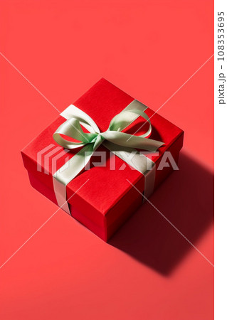 Red gift box with pink bow over red background.  108353695