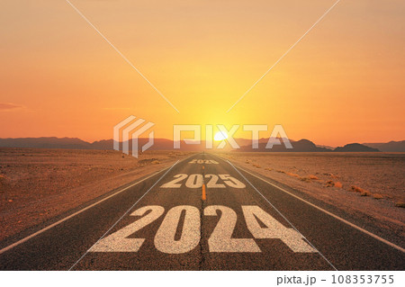 New year 2024 or straight forward concept. Text 2024 written on the road in the middle of asphalt road at sunset. Concept of planning, goal, challenge, new year resolution. 108353755