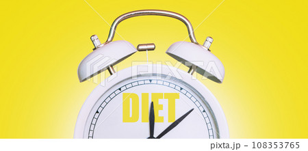 Vintage white clock with diet time on yellow background. Time to diet, creative idea. Losing weight, concept Vintage white clock with diet time on yellow background. Time to diet, creative idea. Losing weight, concept 108353765