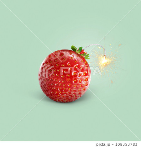 Creative juicy bomb strawberry with wick sparks on a colored green background, concept. Useful vitamins and summer time, creative idea. Fruits and a healthy lifestyle 108353783