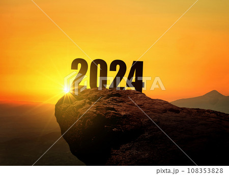 New Year 2024 at sunset. Silhouette 2024 stands on a mountain with sun rays at sunrise, creative idea. Year 2024, concept New Year 2024 at sunset. Silhouette 2024 stands on a mountain with sun rays at sunrise, creative idea. Year 2024, concept 108353828