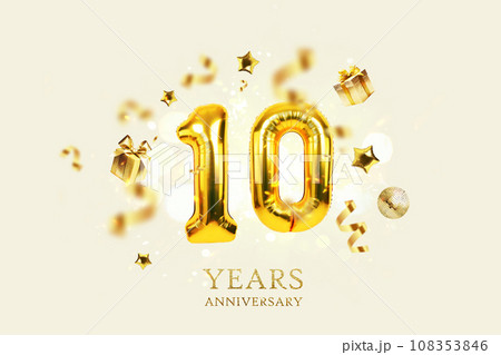 Gold festive balloons 10 years anniversary with golden confetti, presents, mirror ball and stars fly on a beige background with bokeh lights and sparks. Birthday luxury ten card, a creative idea 108353846