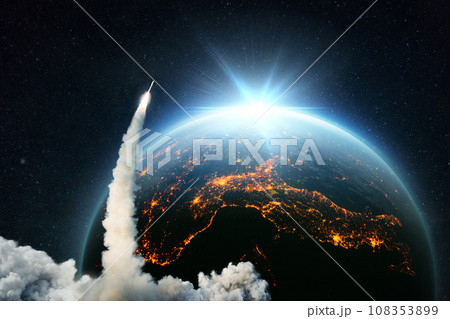 Space Rocket lift off. Space shuttle with smoke and blast takes off into space on a background of blue planet earth with amazing sunset. Successful start of a space mission. Travel to Earth. Space Rocket lift off. Space shuttle with smoke and blast takes off into space on a background of blue planet earth with amazing sunset. Successful start of a space mission. Travel to Earth. 108353899