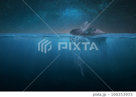 Tip of a drifting iceberg in the water and underwater view on a starry night in the ocean. Global warming and melting glaciers, concept. Danger, creative idea. Iceberg at night 108353933