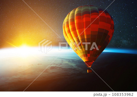 Hot air balloon flies in space with stars over planet earth with sunset. Futuristic travel in space, concept Hot air balloon flies in space with stars over planet earth with sunset. Futuristic travel in space, concept 108353962