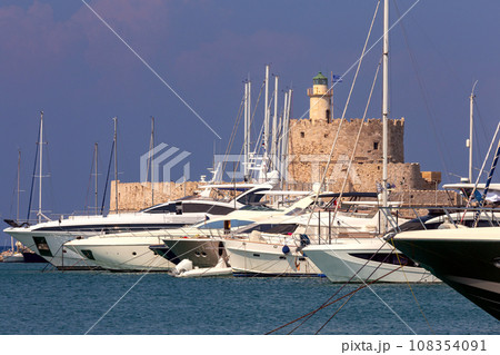 Old stone lighthouse on the breakwater in Rhodes. Old stone lighthouse on the breakwater in Rhodes. 108354091