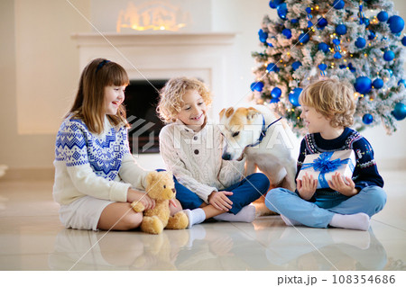 Child at Christmas tree. Kids at fireplace on Xmas 108354686