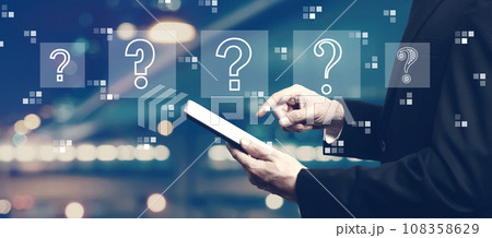 Question marks with businessman using a tablet Question marks with businessman using a tablet 108358629