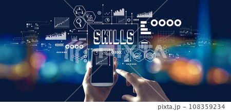 Skills theme with person using a smartphone at night 108359234