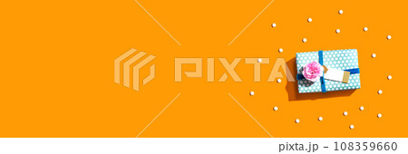 Gift box with carnation flower overhead view 108359660